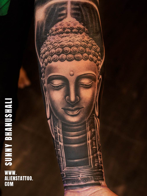 black and grey buddha portrait tattoo