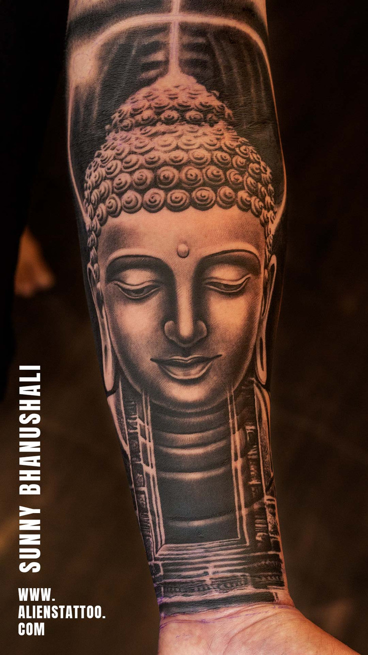 black and grey buddha portrait tattoo